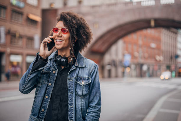 istock Young guy talking on mobile on the street 1172487935