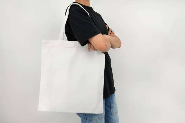 istock young woman holding eco cotton bag isolate on white background 1172488630