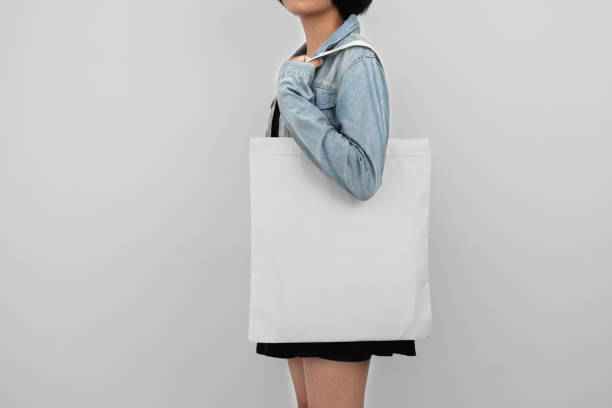 istock young woman holding eco cotton bag isolate on white background 1172488643