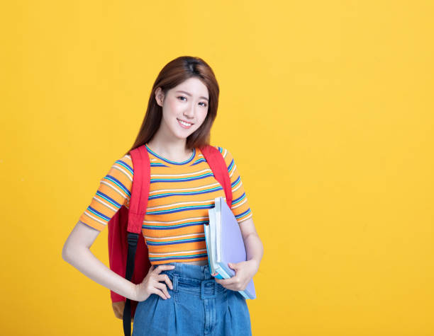 istock beautiful asian young student holding books 1172490405