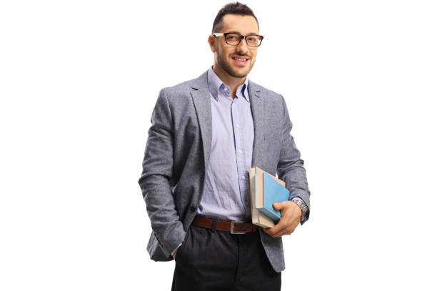 Young man holding books and smiling at the camera isolated on white background