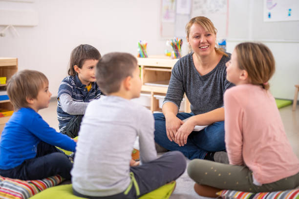 istock Teacher and students sitting in a circle 1172490529
