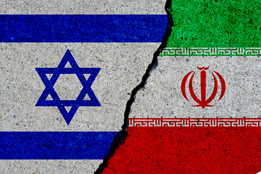 israel and iran flags painted over cracked concrete wall