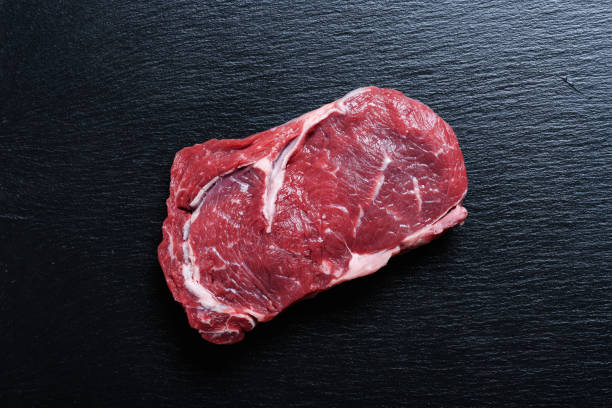 istock Raw rib eye steak on a slate plate 1172491096