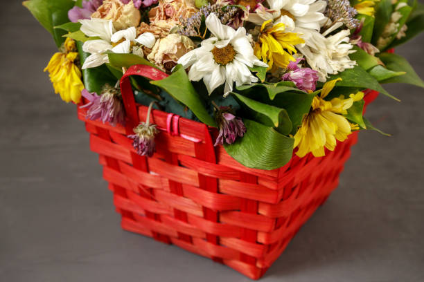 istock withered festive floral bouquet with different flowers in a red wicker decorative basket 1172492426