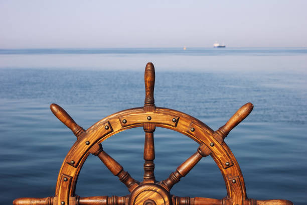 Steering hand wheel ship on sea background stock photo