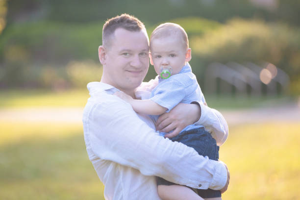 istock Portrait of a father with his son on his hands 1172501848