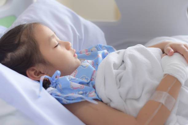 istock Patient child sleeping on hospital bed with saline solution intravenous 1172502620