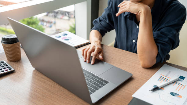 istock Midsection Of Man Using Laptop At Table In Office 1172505821