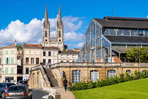 Niort, France - May 11, 2019: Steeples of the Saint-Andre church and covered market hall of Baltard style in old town of Niort, Deux-Sevres, France