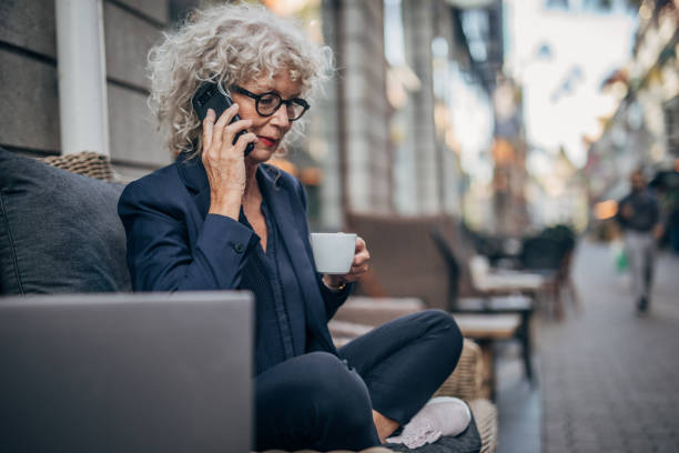 istock Woman talking on mobile outdoors in cafe 1172508262
