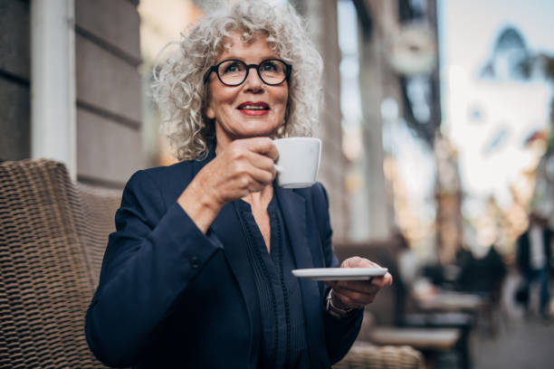 istock Charming lady drinking coffee in cafe outdoors 1172508776