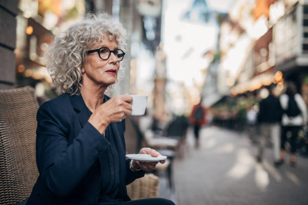 istock Lady drinking coffee in cafe outdoors 1172509318