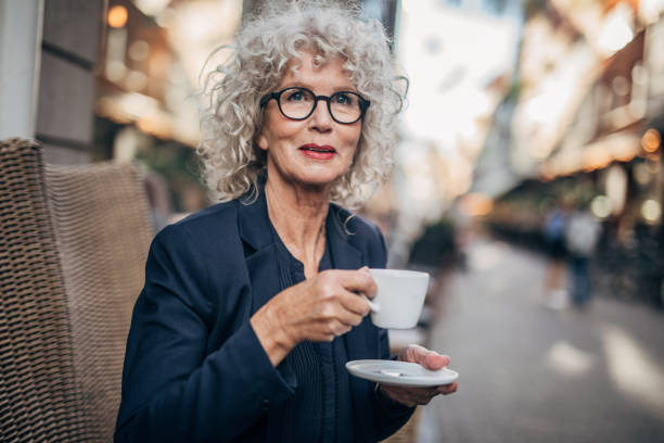 istock Charming lady drinking coffee in cafe outdoors 1172509362