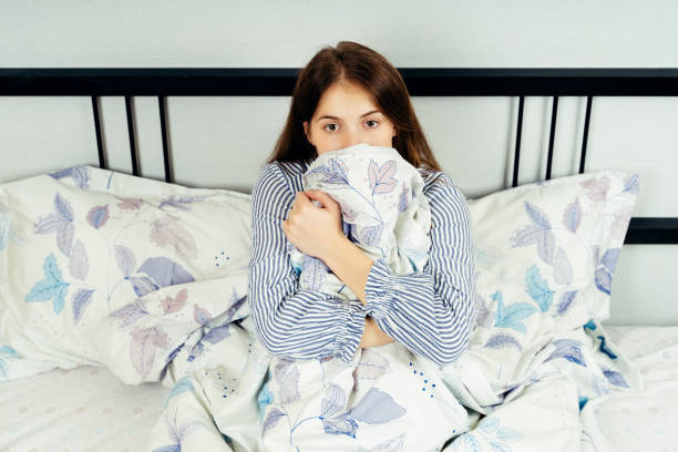 istock Young woman sitting alone on the bed 1172510365