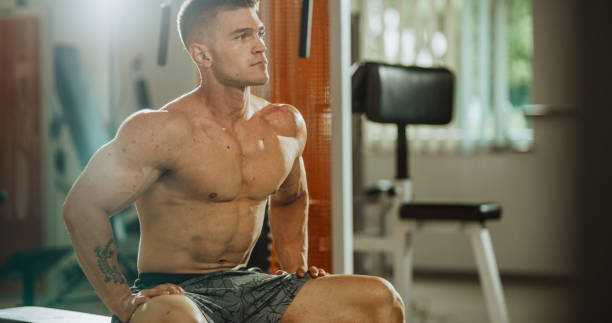 istock Man sitting on bench at gym 1172515282