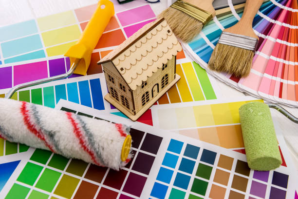 istock Wooden house model and roller on color palette 1172516482