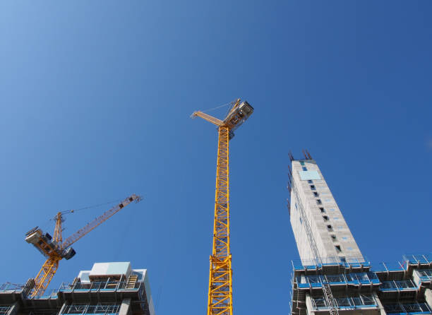 istock a view of tall tower cranes working on large construction sites against a blue sky in leeds england 1172518663