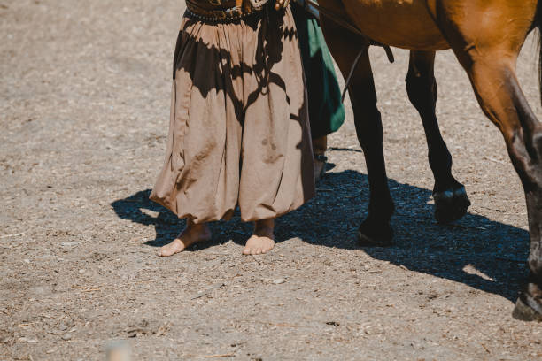 istock bareback rider stands in front of horse 1172520015