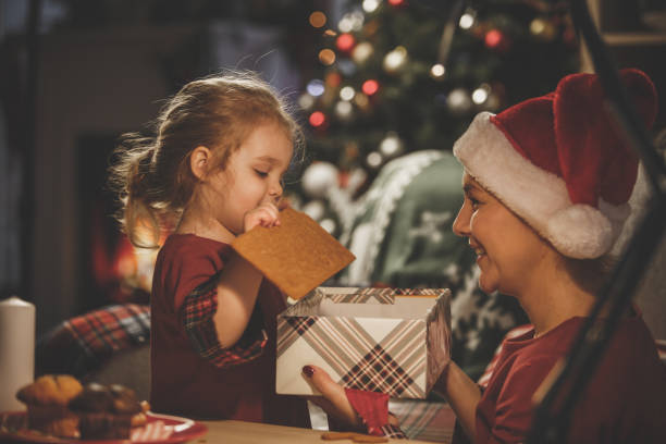 istock Mother and daughter enjoying Christmas tradition 1172528012