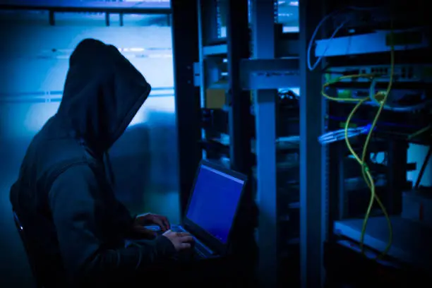 The hacker has hidden in the organization or company and is trying to steal important information from the company's server room.