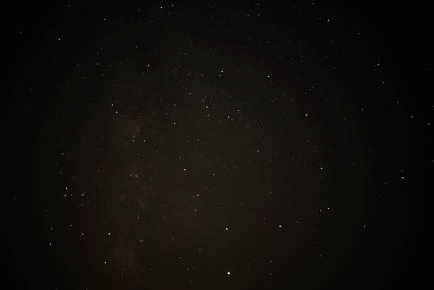istock Night starry sky and man with lamp. Long exposure photography. 1172533202