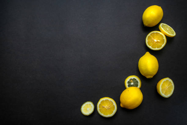 istock Colorful lemons on black background 1172533415