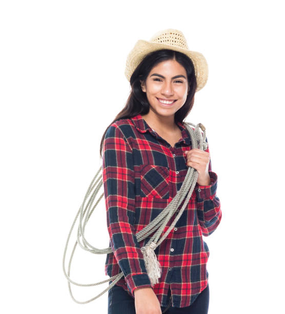 Full length of 20-29 years old beautiful latin american and hispanic ethnicity female / young women cowgirl in front of white background wearing cowboy boot / cowboy hat / hat / boot / plaid shirt who is smiling / happy / cheerful and holding lasso Full length of 20-29 years old beautiful latin american and hispanic ethnicity female / young women cowgirl in front of white background wearing cowboy boot / cowboy hat / hat / boot / plaid shirt who is smiling / happy / cheerful and holding lasso / using rope checkered cowboy boots stock pictures, royalty-free photos & images