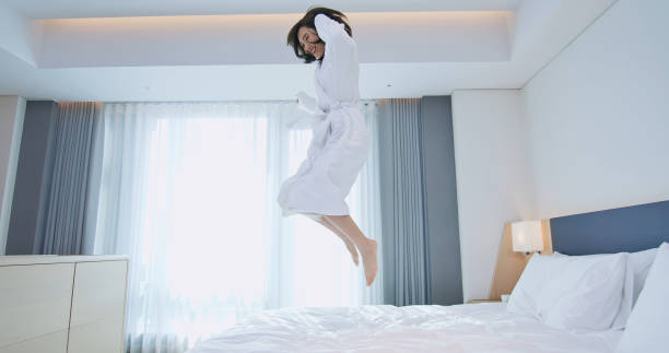 istock Excited woman jump with bathrobe 1172534788