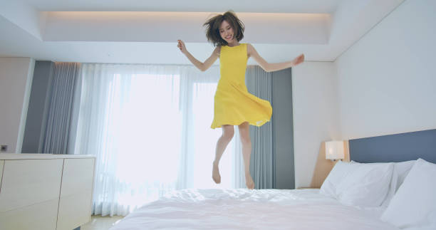istock Fashion lady jump on bed 1172537008