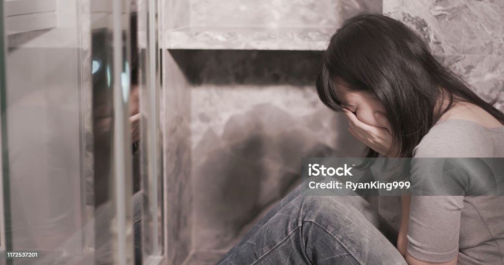 woman feel depress in corner woman feel depressed and hide in the corner Bathroom Stock Photo