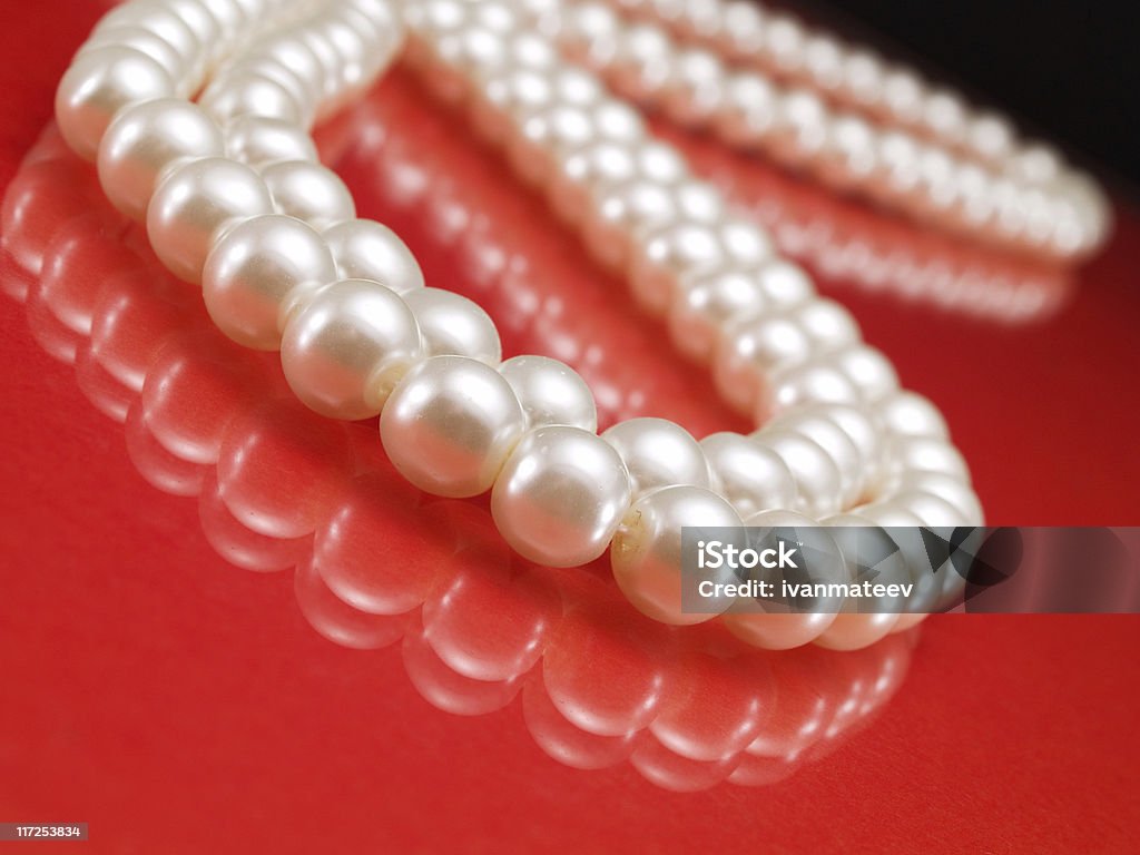 Pearl Necklace Pearl Necklace on red Pearl Jewelry Stock Photo