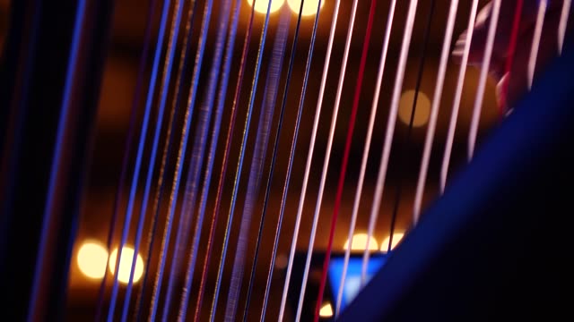 Close up of harpist playing the harp with delicate fingers