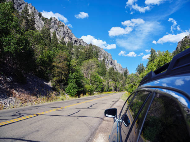 A car on a mountain rural road in summer.