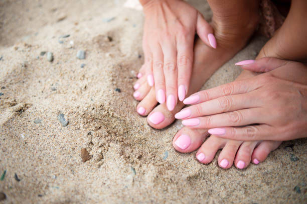 istock Young lady is showing her light pink manicure and pedicure nails 1172551219