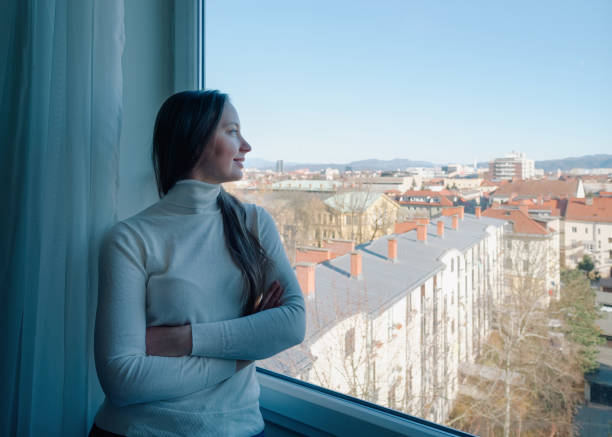 istock Girl looking through window on Ljubljana 1172551316