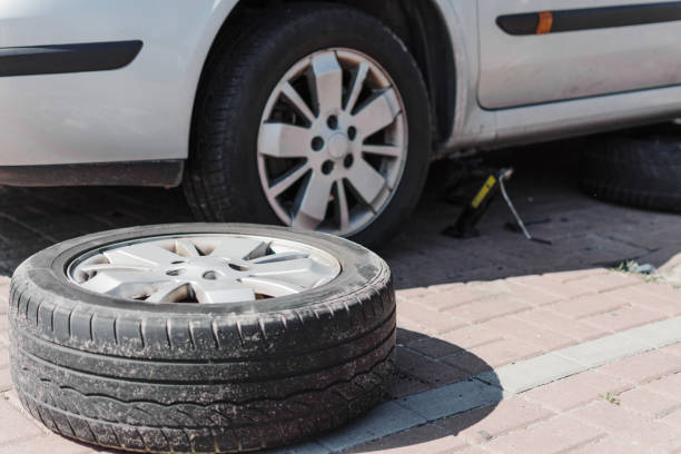istock Mechanic changing wheel on car with a wrench. 1172552521