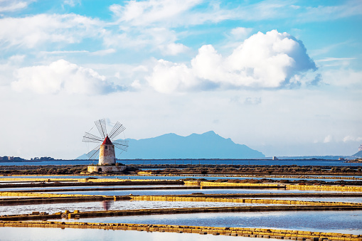 Old mill of the Infersa salt flats, famous Trapani and Paceco salt flats nature reserve on Via del Sale.
Trapani, Sicily, Ital