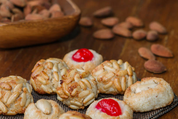 istock Closeup plate with Catalan panellets and some roasted almonds on a wooden table. Typical desert in Catalonia for Halloween (La Castanyada) 1172556736
