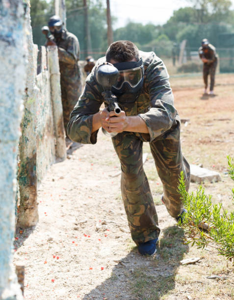 istock Male paintball player aiming with gun 1172557296