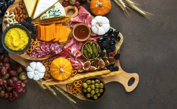 Fall party charcuterie board, view from above Fall party charcuterie board culinary background, view from above, blank space for a text salumeria stock pictures, royalty-free photos & images