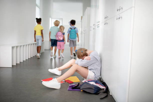 istock Girl wearing white sneakers sitting and crying while feeling lonely 1172559825