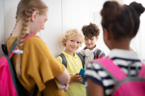 istock Classmates standing near lockers and enjoying school break 1172560018