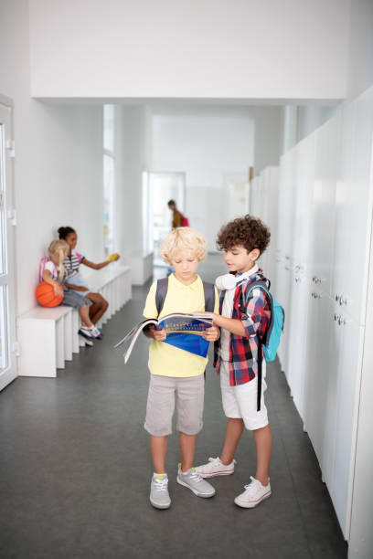 istock Boys standing in school corridor and repeating material before lesson 1172560048