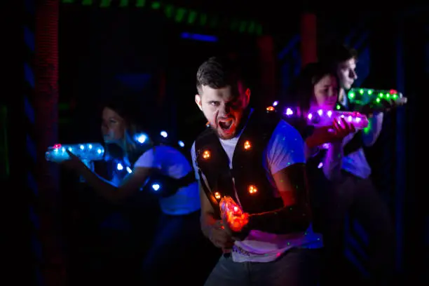 Photo of Excited guy during lasertag game