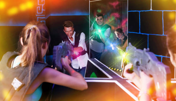 istock Excited people playing enthusiastically laser tag game 1172561149