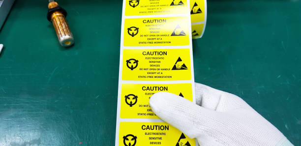 istock Hand holding ESD symbol label with antistatic gloves,Electrostatic Sensitive Devices (ESD) in electronic industrial. 1172561863