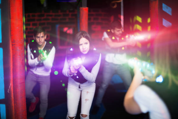 istock Female laser tag player in bright beams 1172562210