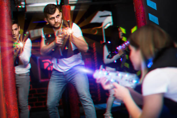 istock Excited guy laser tag player in bright beams 1172562212