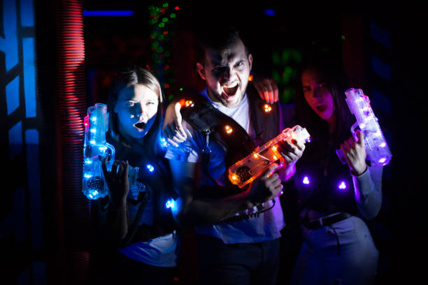istock Young people in laser tag labyrinth 1172562235